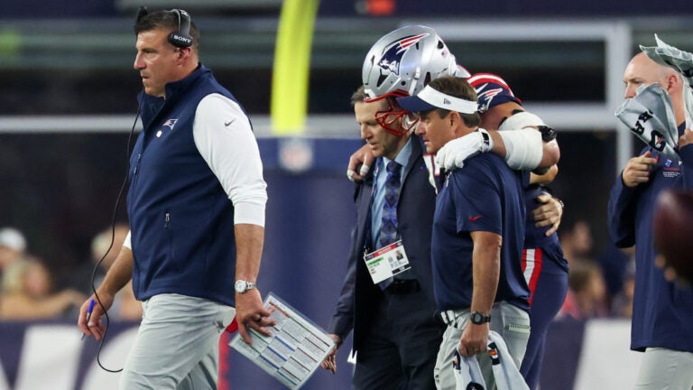 New England Patriots offensive lineman Ben Brown is helped off the field after an injury against the Indianapolis Colts as head coach Mike Vrabel walks towards the bench during the first half of an NFL preseason football game, Thursday, Aug. 13, 2026, in Foxborough, Mass.