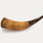The man was polishing a powder hornaiting to pick up his wife from work at the chapel. As he waited, he was polishing a powder horn, which is a musket-era gunpowder container in the shape of a bull&rsquo;s horn.