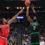 Boston Celtics guard Jaylen Brown, right, shoots a as Los Angeles Clippers forward Kawhi Leonard defends during the first half of an NBA basketball game Saturday, Jan. 3, 2026, in Inglewood, Calif.