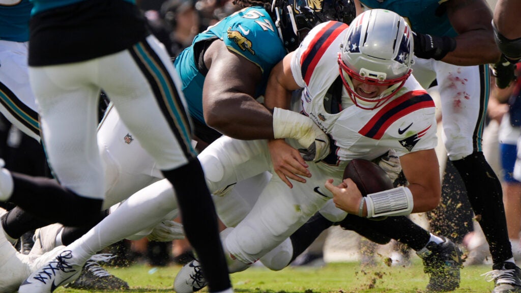 Jacksonville Jaguars defensive tackle Davon Hamilton (52) tackles New England Patriots quarterback Drake Maye (10) in the first half during an NFL football game in Jacksonville, Fla., Sunday, Sept. 27, 2026.