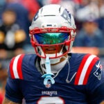 New England Patriots cornerback Christian Gonzalez (0) wears a reflective face shield prior to an NFL football game against the Pittsburgh Steelers in Foxborough, Mass., Sunday, Sept. 20, 2026.