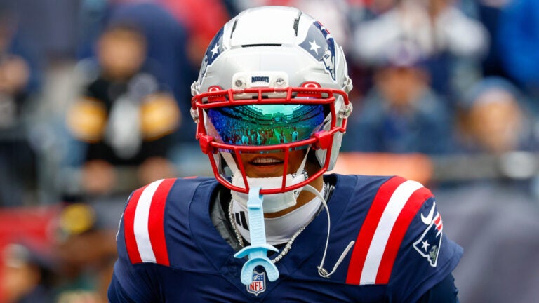 New England Patriots cornerback Christian Gonzalez (0) wears a reflective face shield prior to an NFL football game against the Pittsburgh Steelers in Foxborough, Mass., Sunday, Sept. 20, 2026.