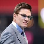 ATLANTA, GEORGIA - OCTOBER 18: Sports analyst Tom Brady looks on prior to the game between the Atlanta Falcons and the Chicago Bears at Mercedes-Benz Stadium on October 18, 2026 in Atlanta, Georgia.