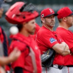 Boston Red Sox game planning and run prevention coach Jason Varitek (second from right) on the field during spring training at JetBlue Park.