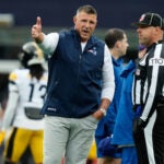 New England Patriots head coach Mike Vrabel, left, talks to an official before an NFL football game against the Pittsburgh Steelers, Sunday, Sept. 20, 2026, in Foxboro, Mass.