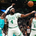 Boston Celtics center/forward Mitchell Robinson (4) battles for a defensive rebound during the 2nd quarter. The Boston Celtics host the Charlotte Hornets in a pre season exhibition game Wednesday, October 14, 2026 at TD Garden in Boston, MA.