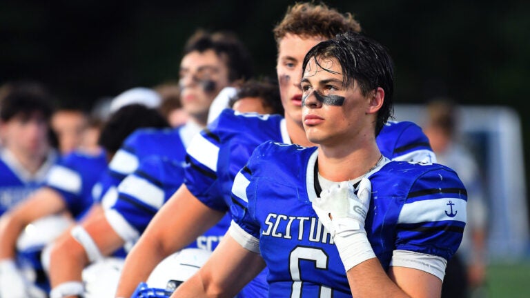 Duxbury at Scituate High School football. Scituate's Grayson Foley stands with his team for the national anthem.
